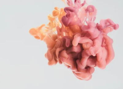 a-drop-of-pink-and-yellow-paint-in-water